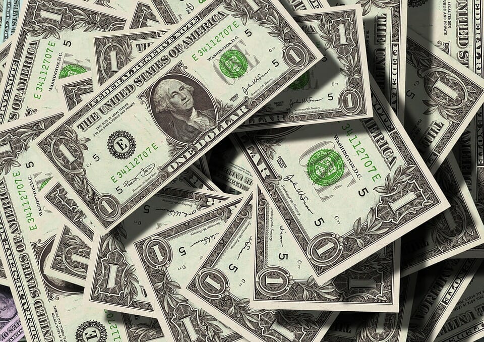 A pile of American one dollar bills
